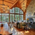 Soaring ceilings in main level with stone fireplace
