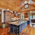 Open-concept kitchen with large island and hanging light fixtures