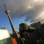 Camera poised for a sky shot near Toronto's CN Tower