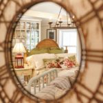 Bedroom setting reflected in mirror at HillTop Interiors