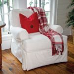 Large comfortable white chair with red cushion
