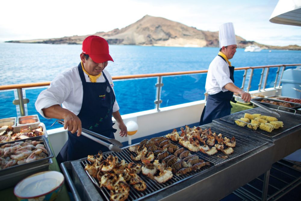Celebrity Xpedition, Xpedition, XP, Galapagos Islands, couple, tour guide, raft boat, tour, life jackets, wet suits, water, landscape, adventure, snorkeling, tours, excursion, service